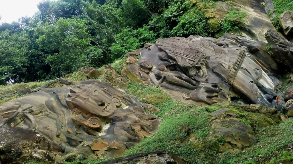 Mountain view of Shiva head and other sculpture at Unakoti rock carvings