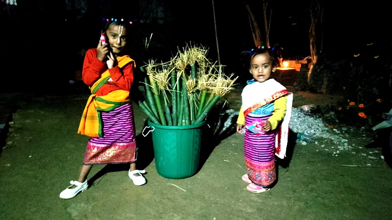Bishnupriya Manipuri girls with freshly made Utang Chak, just before firing them over burning rice straw.